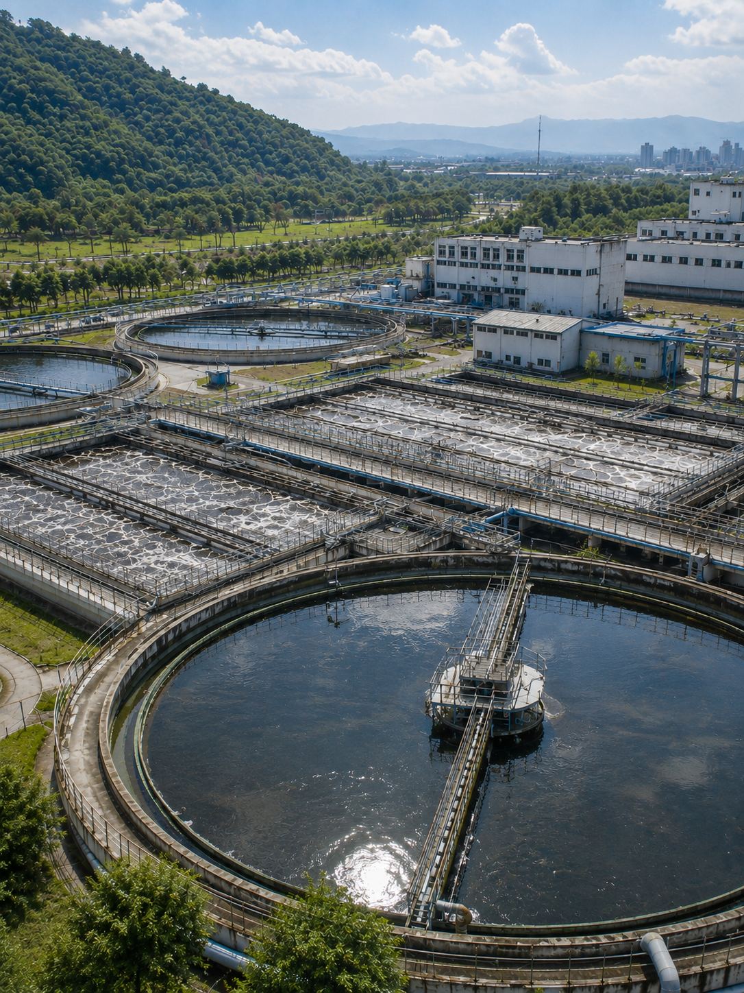 Aerial view of a water treatment facility with clarifiers, aeration basins, and wastewater processing systems
